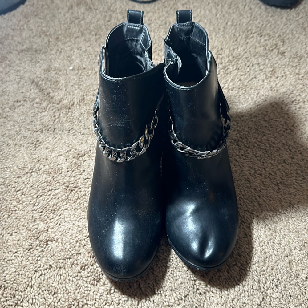 Black booties with silver chain and silver heel detail.